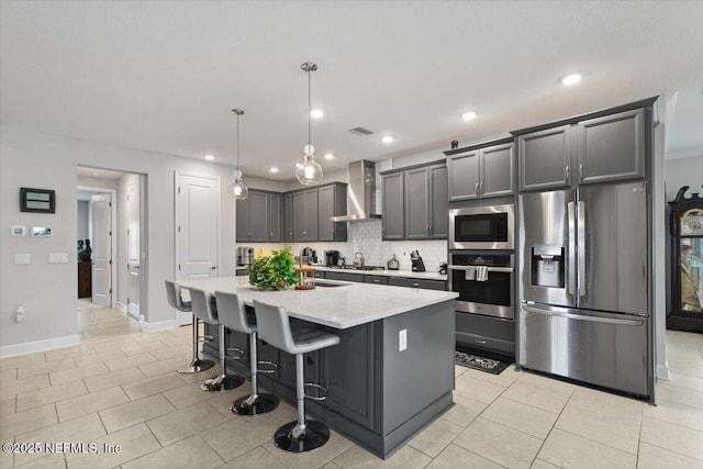 116 Clarendon Rd, Saint Johns, FL 32259 - kitchen with decorative backsplash, visible vents, wall chimney exhaust hood, stainless steel appliances, and a center island with sink