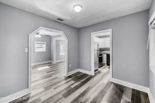 interior space featuring wood finished floors, visible vents, and baseboards