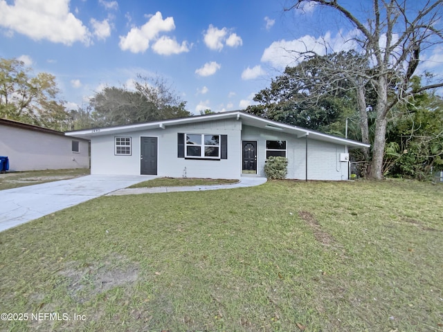 view of front facade with concrete driveway and a front yard