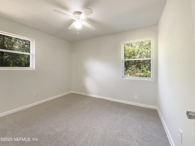 unfurnished room featuring baseboards, carpet floors, and ceiling fan