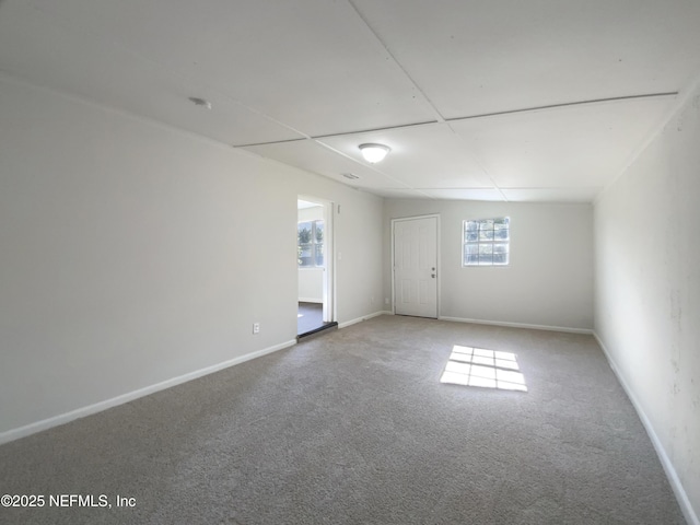 carpeted spare room with baseboards