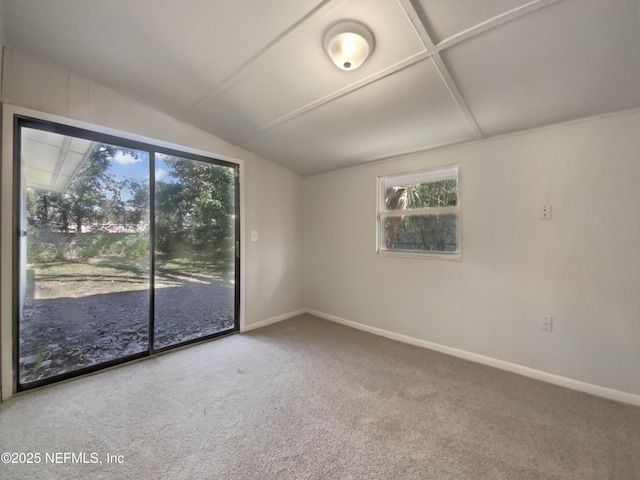 unfurnished room featuring vaulted ceiling, carpet flooring, and baseboards