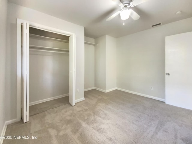 unfurnished bedroom featuring visible vents, baseboards, carpet, and ceiling fan