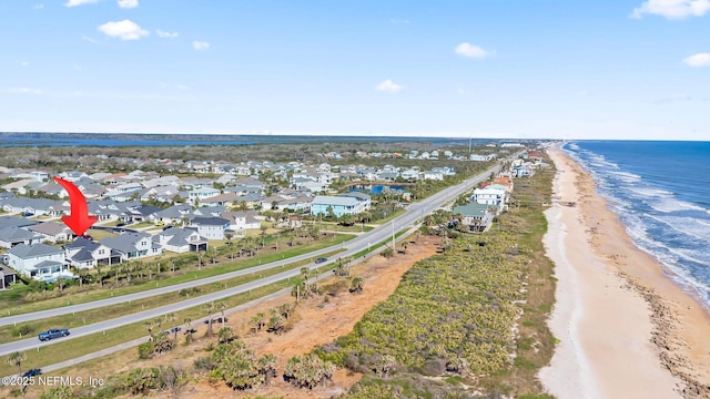 aerial view featuring a residential view, a water view, and a view of the beach