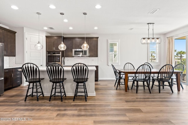 dining area with recessed lighting, dark wood-style floors, visible vents, and baseboards