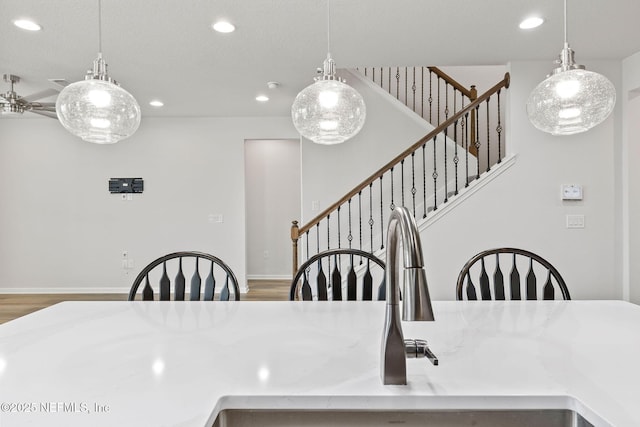 dining space featuring stairs, wood finished floors, recessed lighting, and baseboards