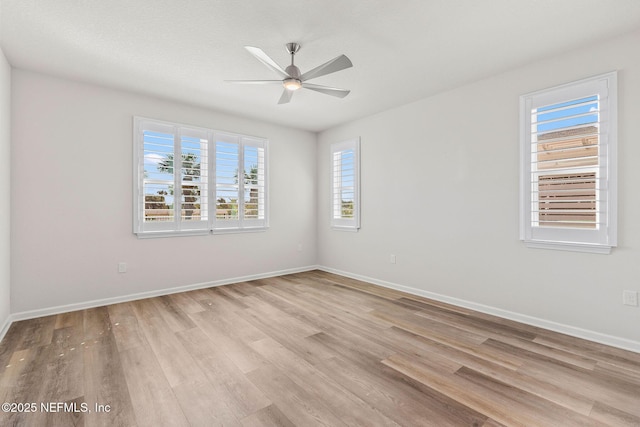 empty room with ceiling fan, baseboards, and light wood-style flooring