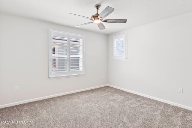 carpeted spare room featuring a textured ceiling, a ceiling fan, and baseboards