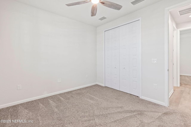 unfurnished bedroom featuring a closet, visible vents, and carpet floors