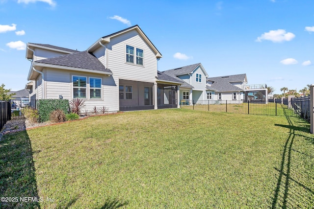 back of property with a fenced backyard, a shingled roof, a yard, and a sunroom