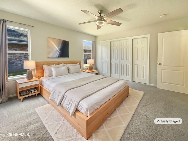 carpeted bedroom featuring a closet, a textured ceiling, baseboards, and a ceiling fan