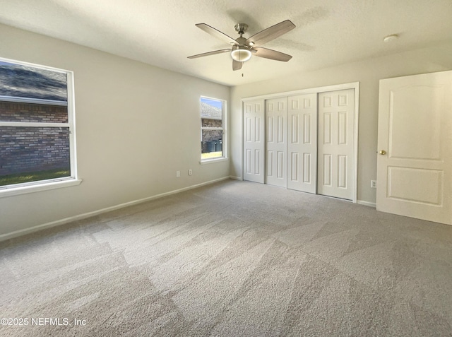 unfurnished bedroom featuring a closet, baseboards, and carpet floors