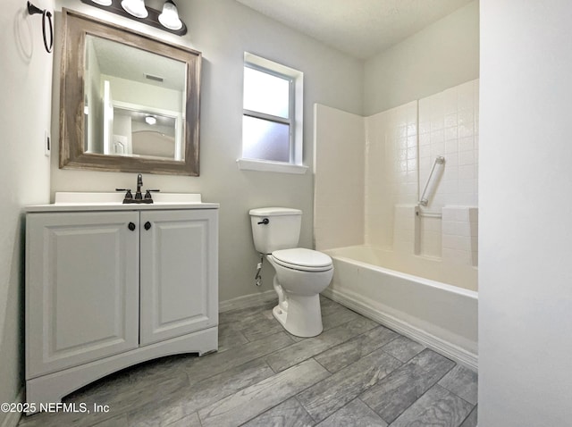 bathroom featuring vanity, washtub / shower combination, visible vents, baseboards, and toilet