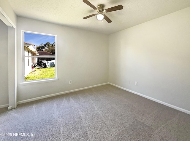 carpeted empty room featuring baseboards, a textured ceiling, and a ceiling fan