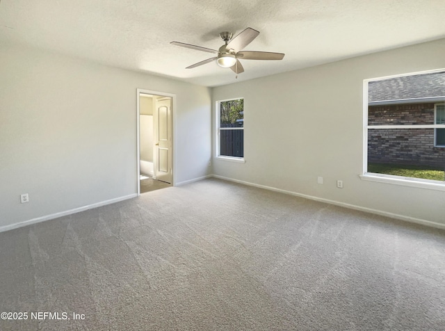 unfurnished room featuring a ceiling fan, carpet, baseboards, and a textured ceiling