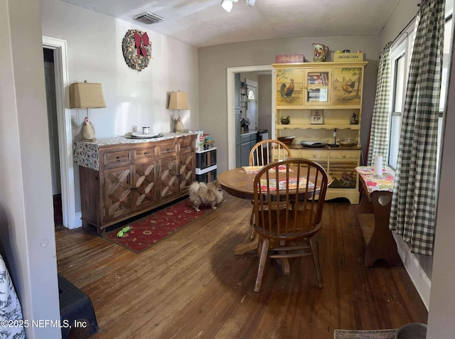 dining room with wood finished floors and visible vents