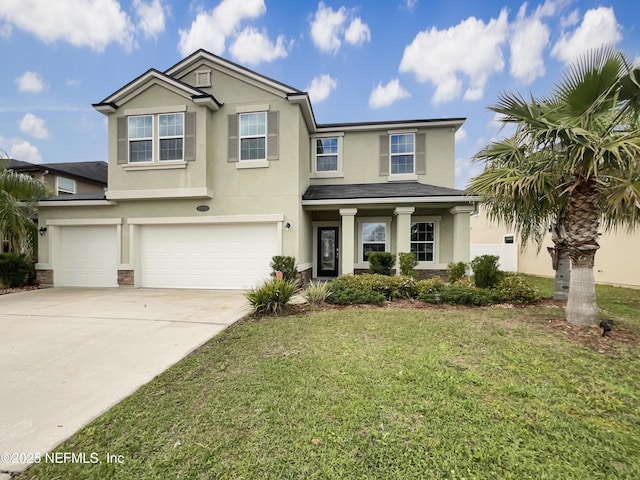 view of front of home with stucco siding, driveway, a front lawn, and a garage