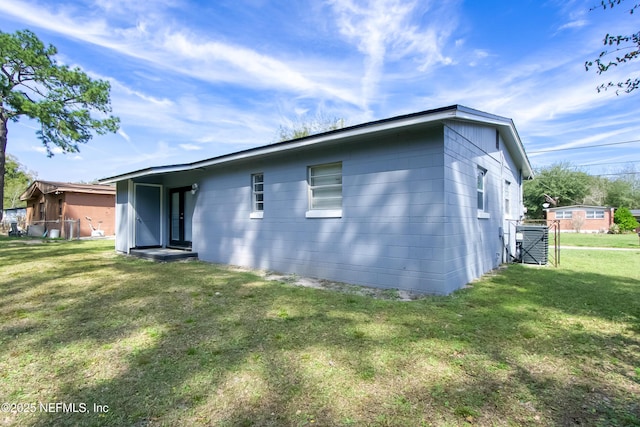 rear view of property with a yard