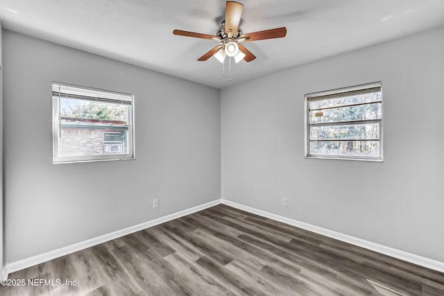 unfurnished room featuring a ceiling fan, wood finished floors, and baseboards