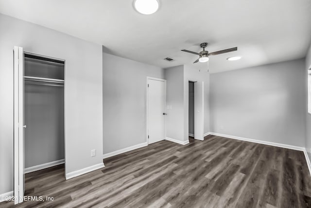 unfurnished bedroom with ceiling fan, visible vents, baseboards, and dark wood finished floors