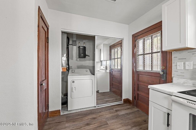 laundry room with baseboards, washer / dryer, and dark wood-style flooring