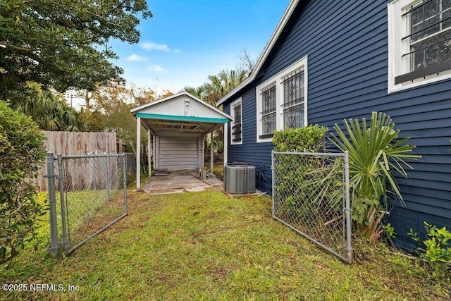 view of yard with a patio area, fence, and central AC