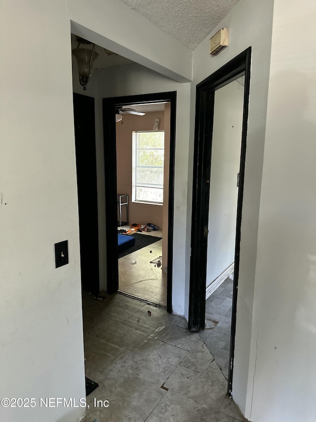 corridor with a textured ceiling