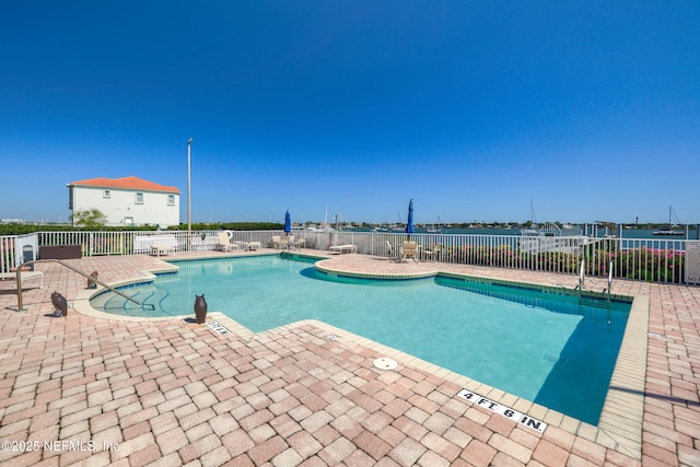 community pool with a patio and fence