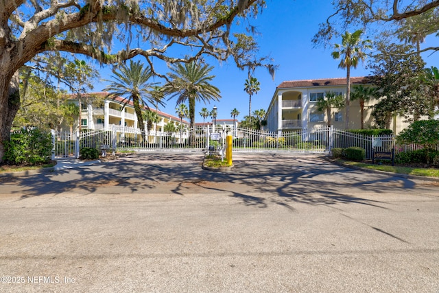 view of property's community featuring a fenced front yard and a gate