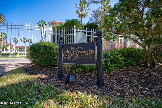 community sign featuring fence