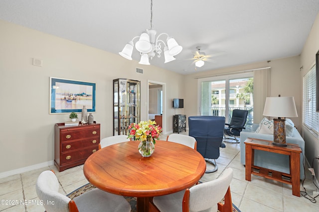 dining room with light tile patterned floors, visible vents, baseboards, and ceiling fan with notable chandelier