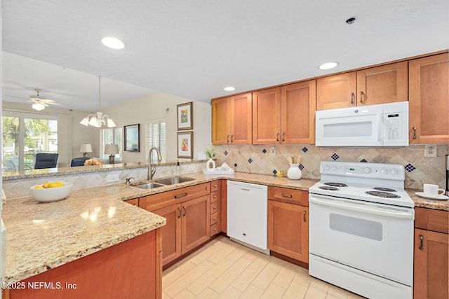 kitchen featuring decorative backsplash, white appliances, brown cabinetry, and a sink