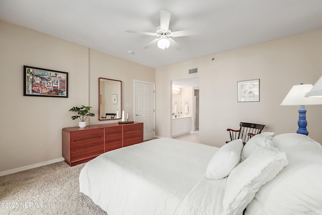 bedroom with visible vents, baseboards, ceiling fan, light colored carpet, and connected bathroom