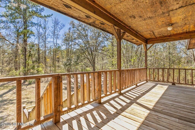 wooden deck with a forest view