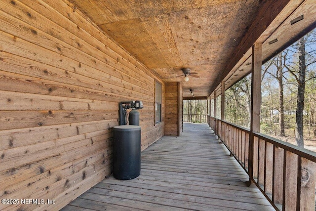 wooden terrace featuring a ceiling fan