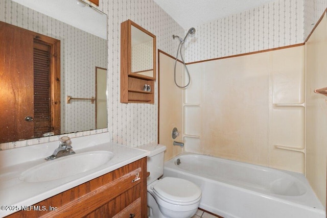 bathroom featuring vanity, wallpapered walls, a textured ceiling, shower / bathing tub combination, and toilet