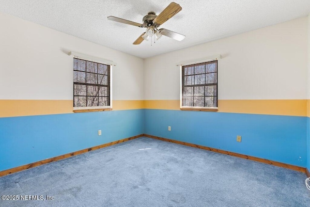 unfurnished room with baseboards, carpet flooring, a textured ceiling, and a ceiling fan