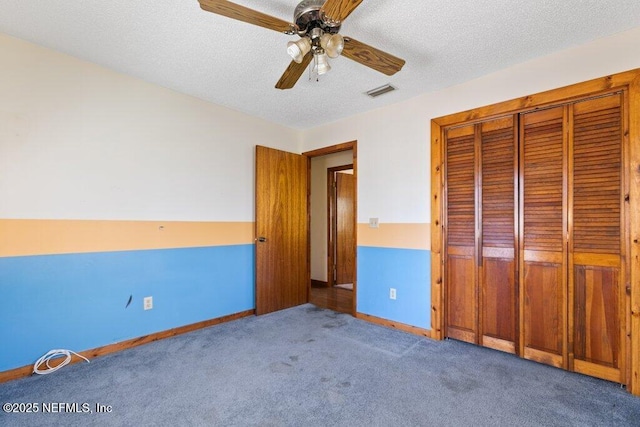 unfurnished bedroom with baseboards, visible vents, carpet floors, a closet, and a textured ceiling