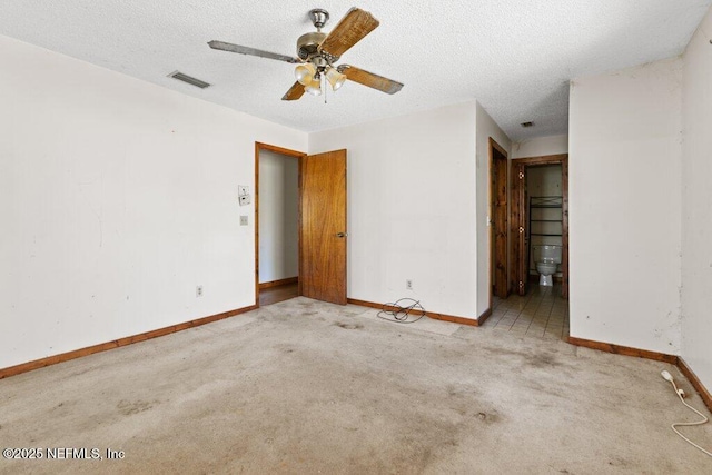 interior space with visible vents, baseboards, and a textured ceiling