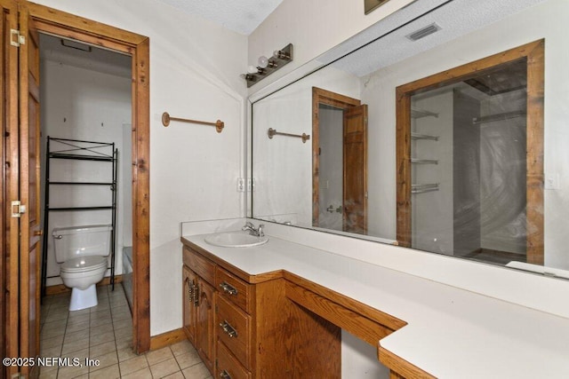 bathroom featuring tile patterned flooring, visible vents, baseboards, toilet, and vanity