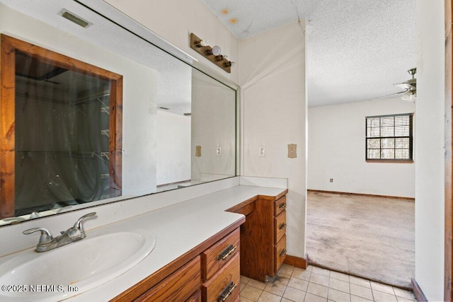 full bath with visible vents, baseboards, vanity, tile patterned floors, and a textured ceiling