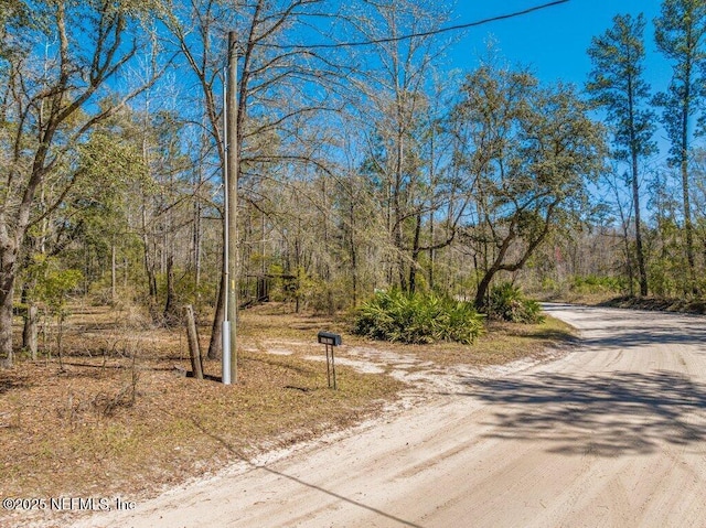 view of street with a wooded view