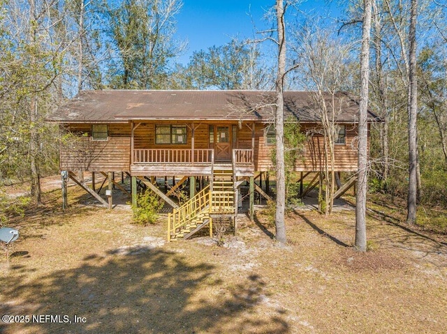 view of front of home featuring stairway and covered porch