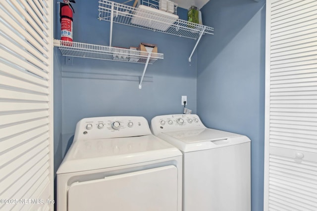 clothes washing area with laundry area and washer and clothes dryer