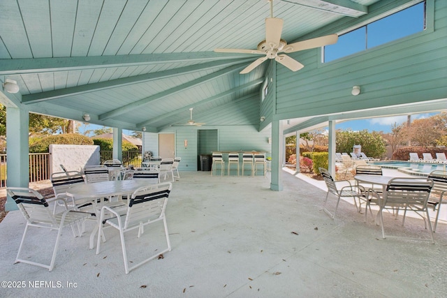 view of patio with outdoor dining space, a fenced in pool, ceiling fan, and fence