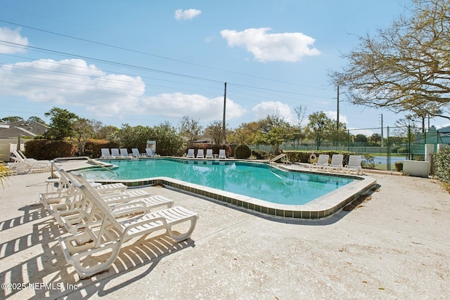 pool featuring a patio area and fence