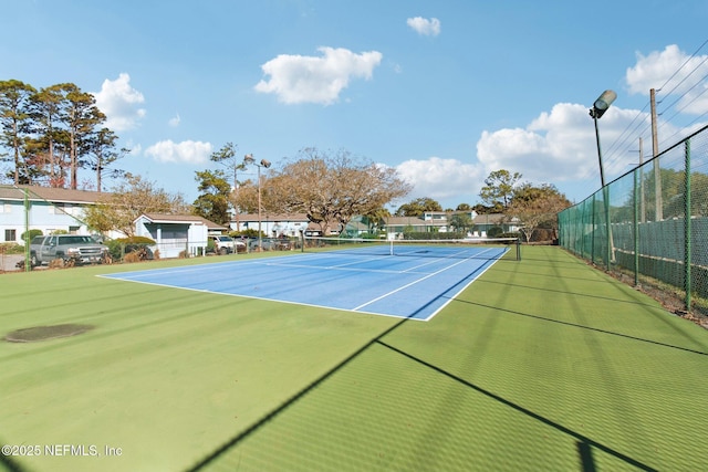 view of tennis court with fence