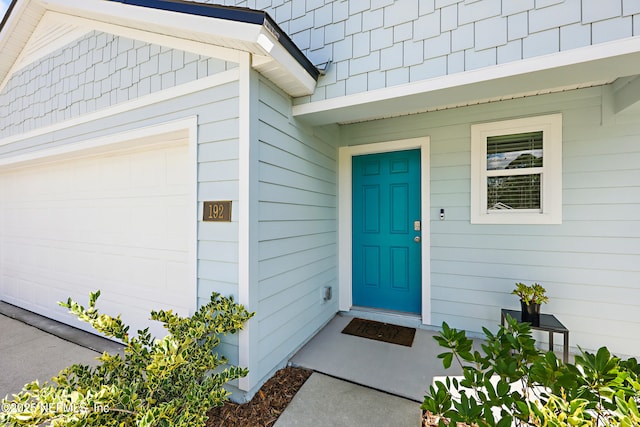 view of exterior entry with a garage