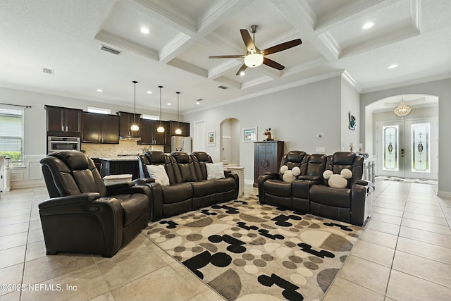 living room featuring light tile patterned floors, visible vents, arched walkways, crown molding, and beamed ceiling