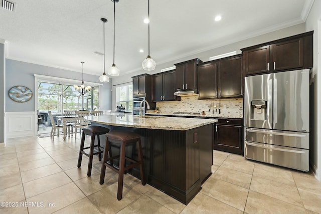 kitchen featuring light tile patterned floors, visible vents, a sink, stainless steel appliances, and crown molding